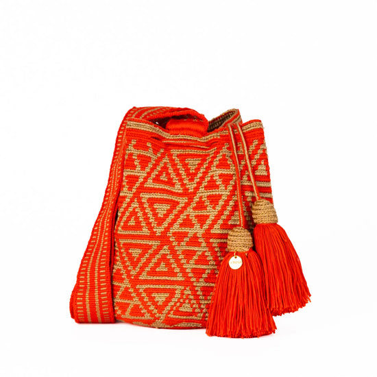 Handcrafted orange and gold striped Wayuu crochet bag made by indigenous artisans in Colombia