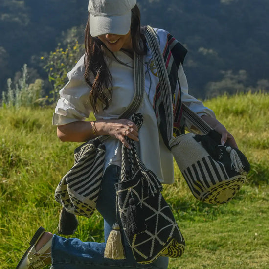 Lifestyle photo of large black and beige Wayuu bags, handmade in Colombia