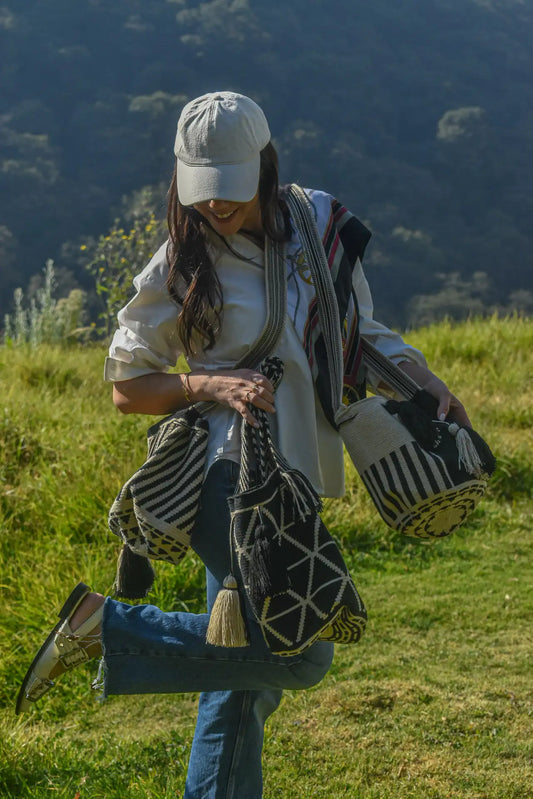 Lifestyle photo of large black and beige Wayuu bags, handmade in Colombia