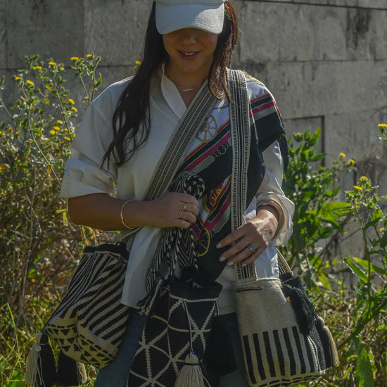 Lifestyle photo of medium black and white Wayuu bags, handmade by artisans in Colombia