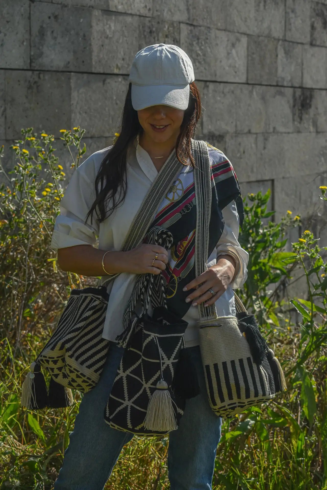 Lifestyle photo of medium black and white Wayuu bags, handmade by artisans in Colombia
