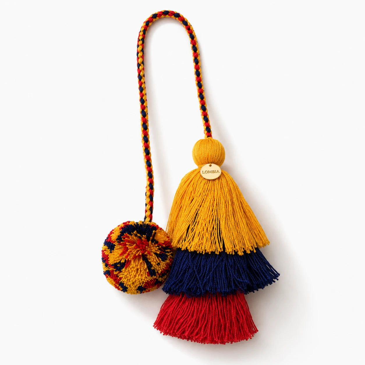 Colorful Colombian tassel keychain with red, yellow, and blue layers on a white background