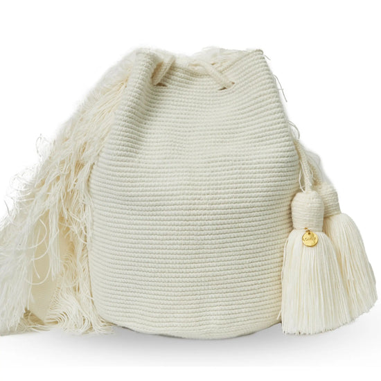Wayuu crochet bag, handmade in a single white color with fringes on the sides by indigenous artisans from Colombia.
