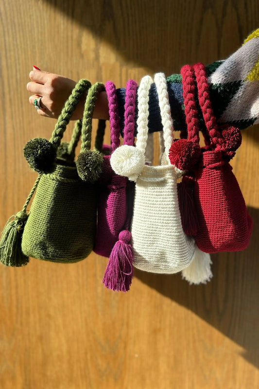 Colorful, Christmas-perfect crochet bags with pom-poms and tassels, made in Colombia by Wayuu artisans