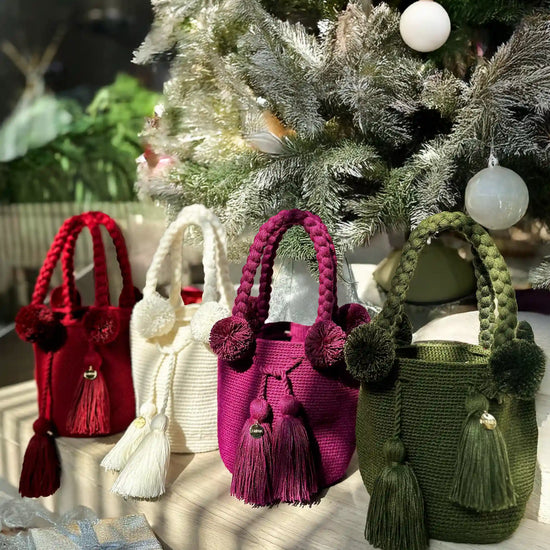 Colorful, Christmas-perfect crochet bags with pom-poms and tassels, made in Colombia by Wayuu artisans