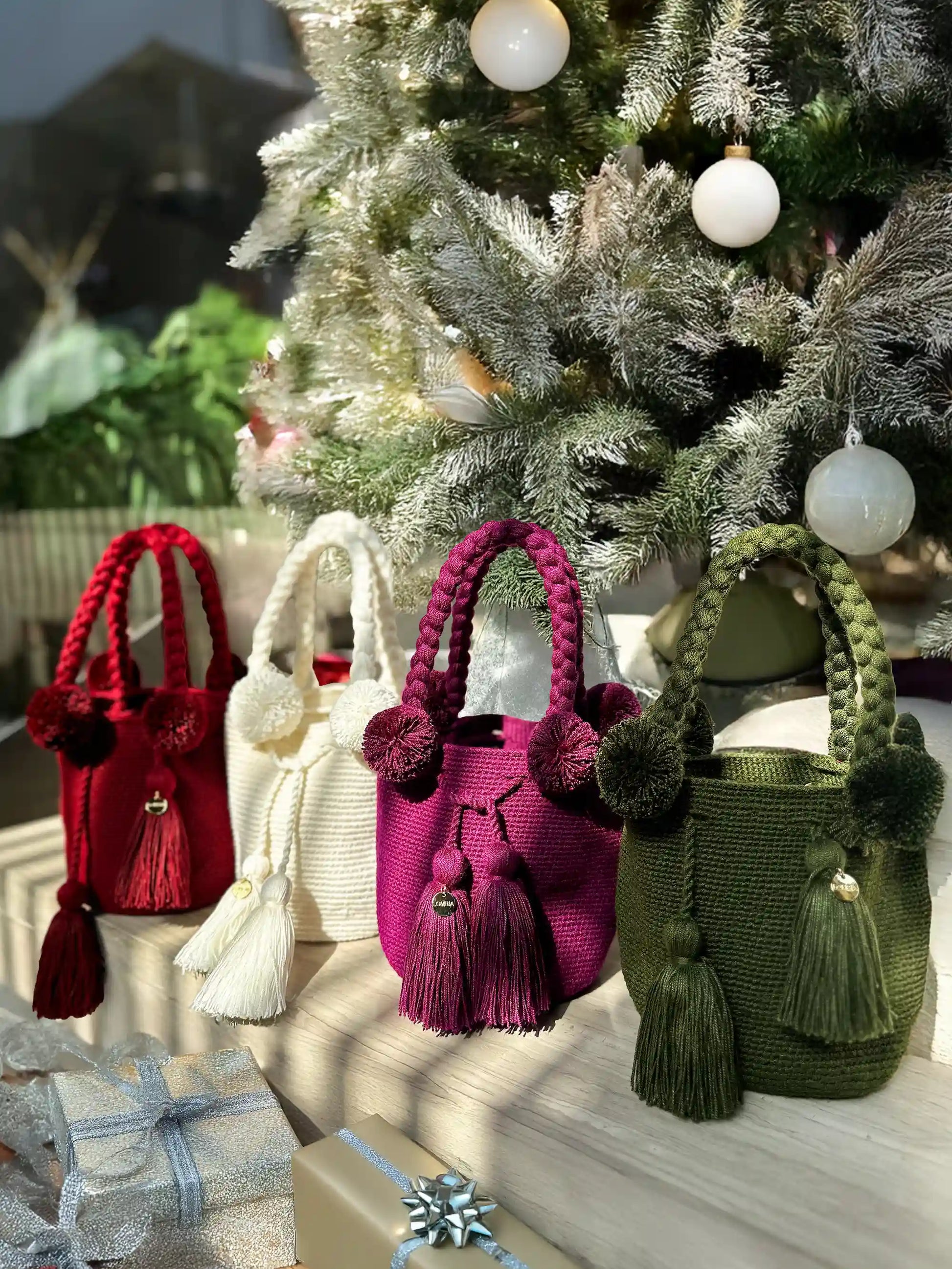 Colorful, Christmas-perfect crochet bags with pom-poms and tassels, made in Colombia by Wayuu artisans