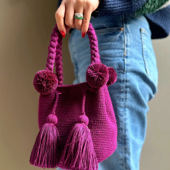 Magenda crochet bag with pom-poms and tassels, made in Colombia by Wayuu artisans