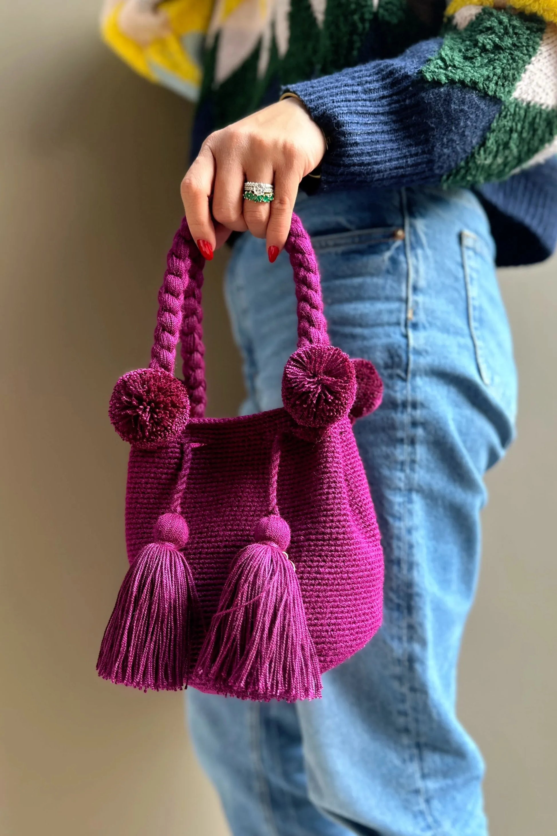 Magenda crochet bag with pom-poms and tassels, made in Colombia by Wayuu artisans