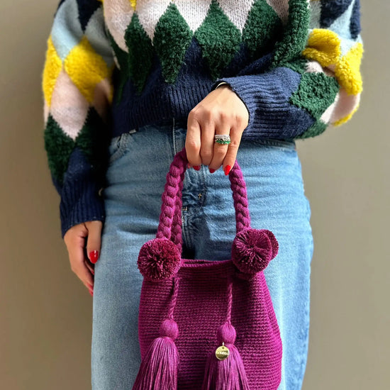 Magenda crochet bag with pom-poms and tassels, made in Colombia by Wayuu artisans